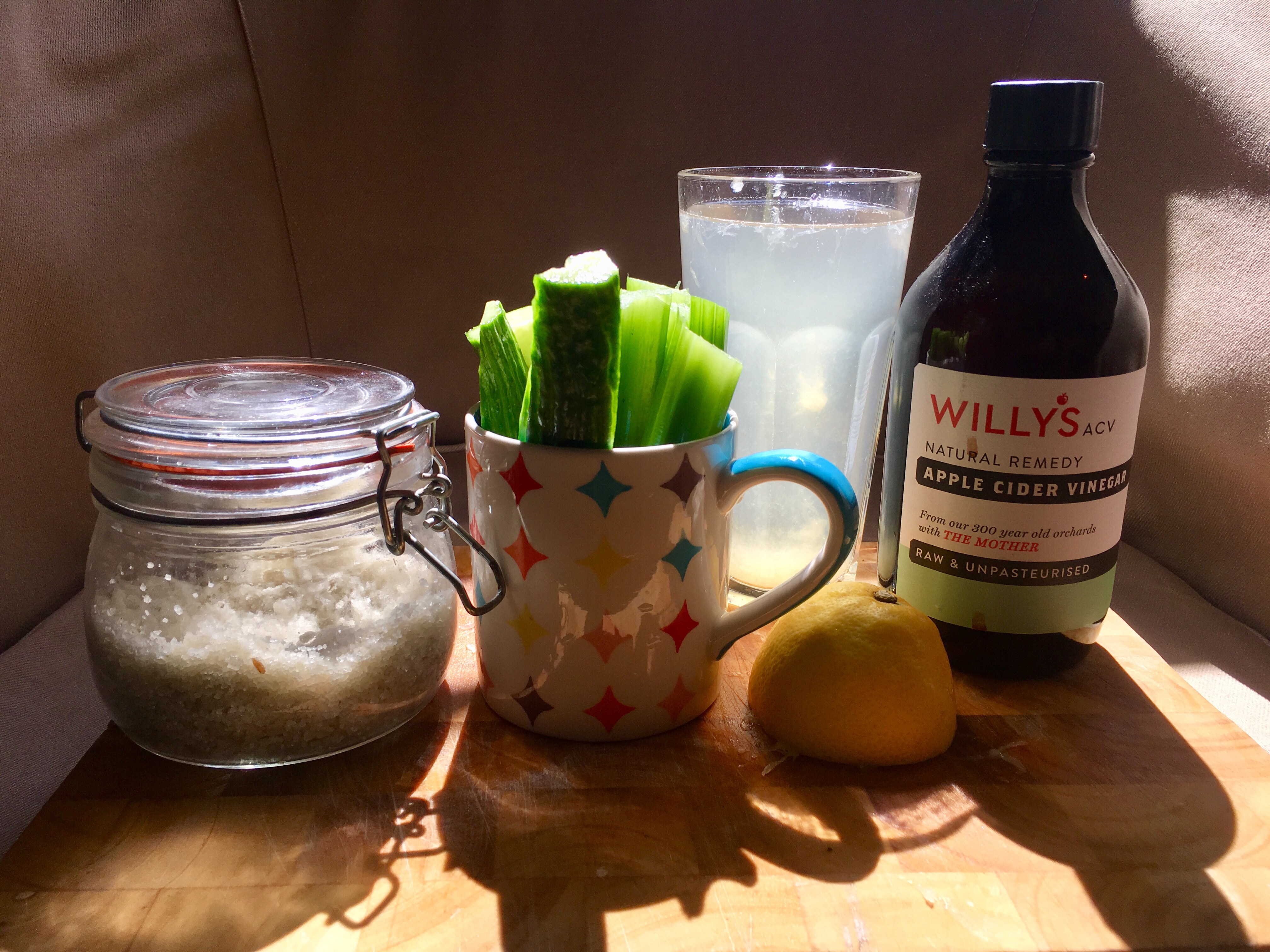 Scene showing salt, cucumber, celery and lemon/ACV water