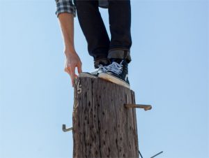 Person standing on a pole